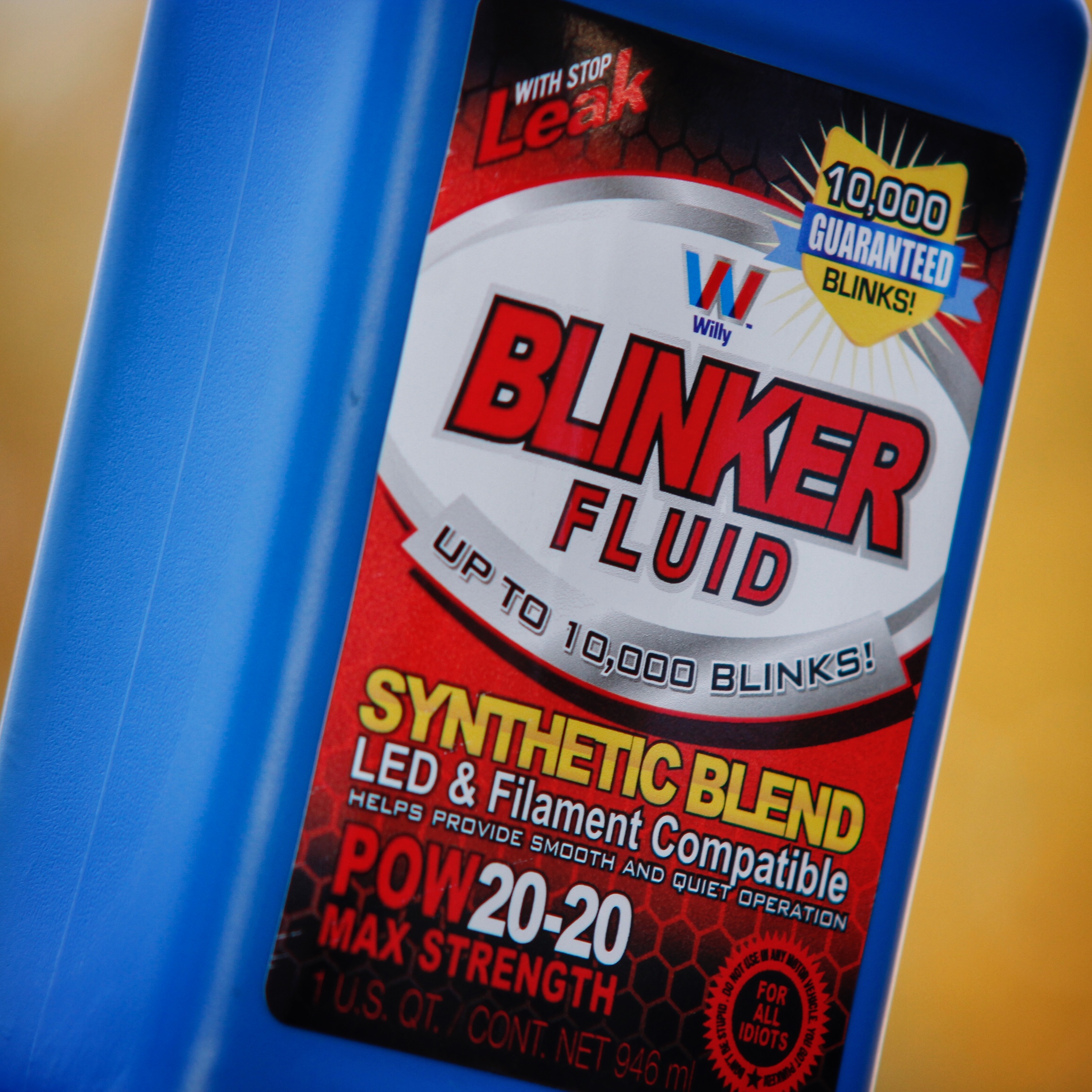Blinker Fluid sticker applied to a blue container in close-up